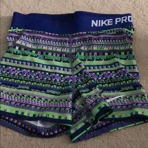 Purple green and blue Nike pros